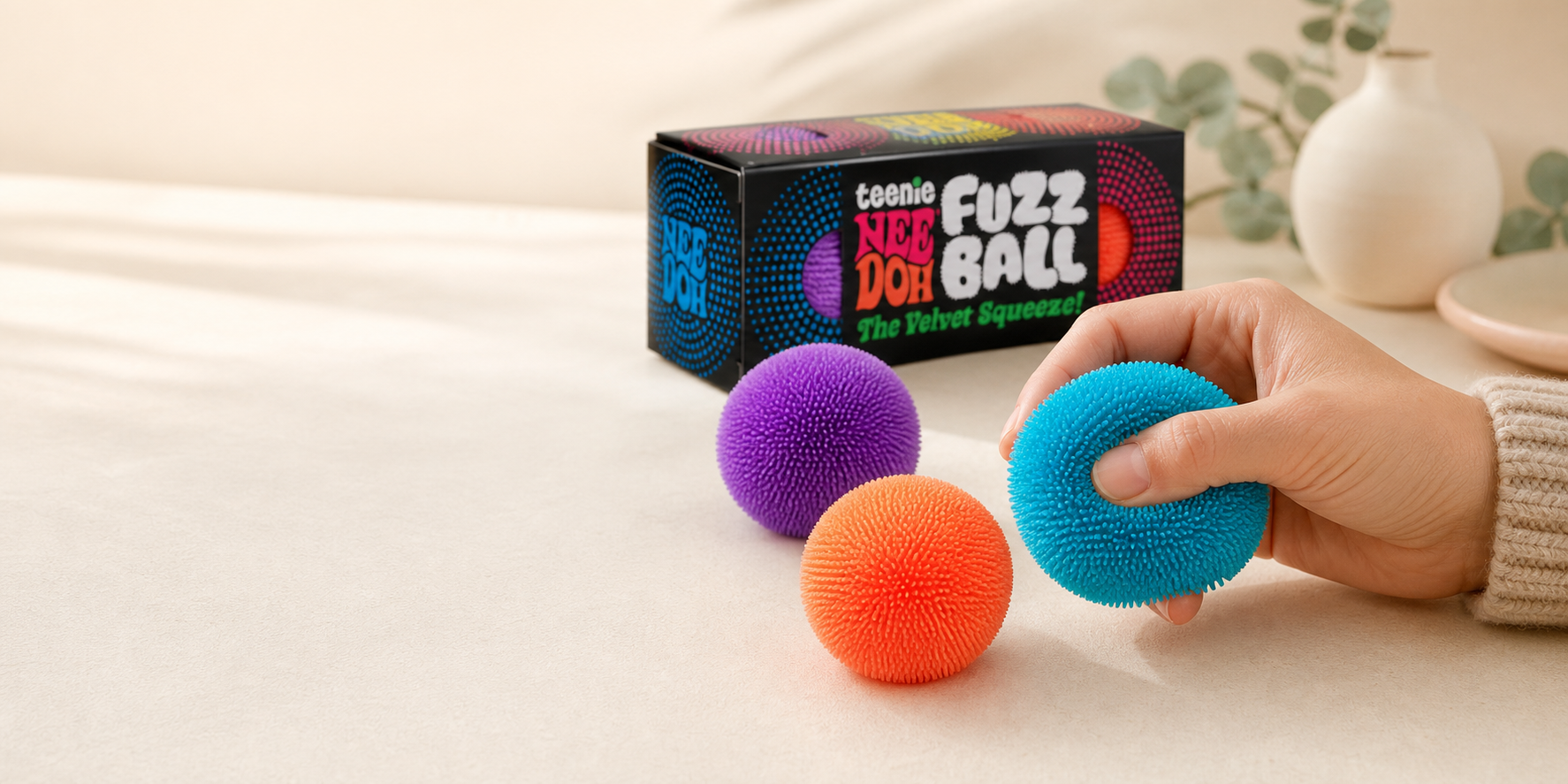 Colorful fuzzy sensory balls in a warm lifestyle scene.